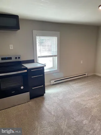 a view of an empty room with a fireplace