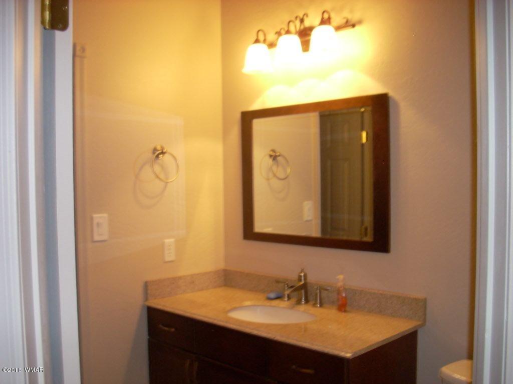 2024 Christmas Pine Road Overgaard, AZ 85933 - Photo 42 of 48 a bathroom with a sink and a mirror
