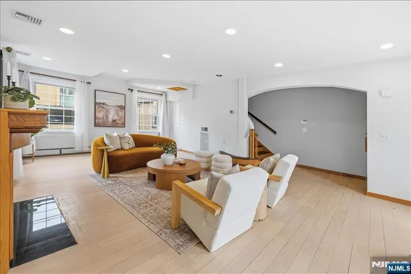a living room with furniture a fireplace and a large window