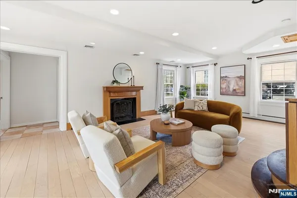 a living room with kitchen island furniture and a potted plant