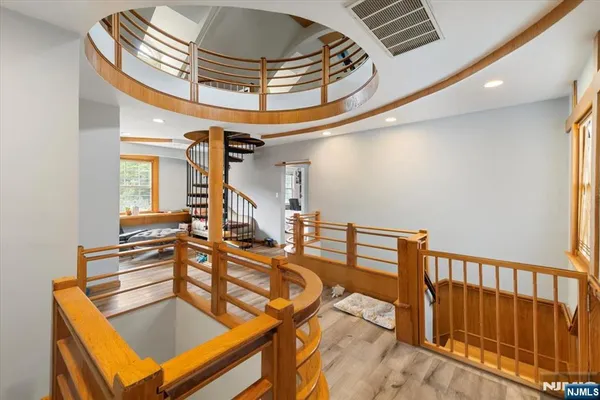a kitchen with stainless steel appliances a stove a sink a microwave a dining table and chairs