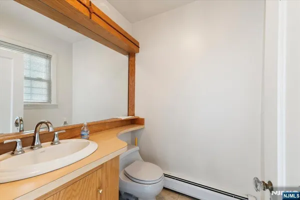 a bathroom with a tub a sink and a large mirror