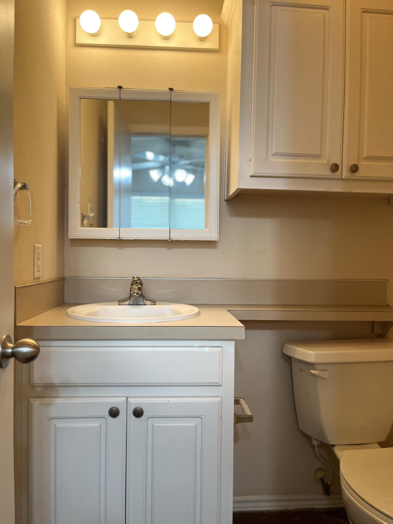 2401 73rd Street, Unit 6 Lubbock, TX 79423 - Photo 15 of 19 a bathroom with a sink a toilet and mirror