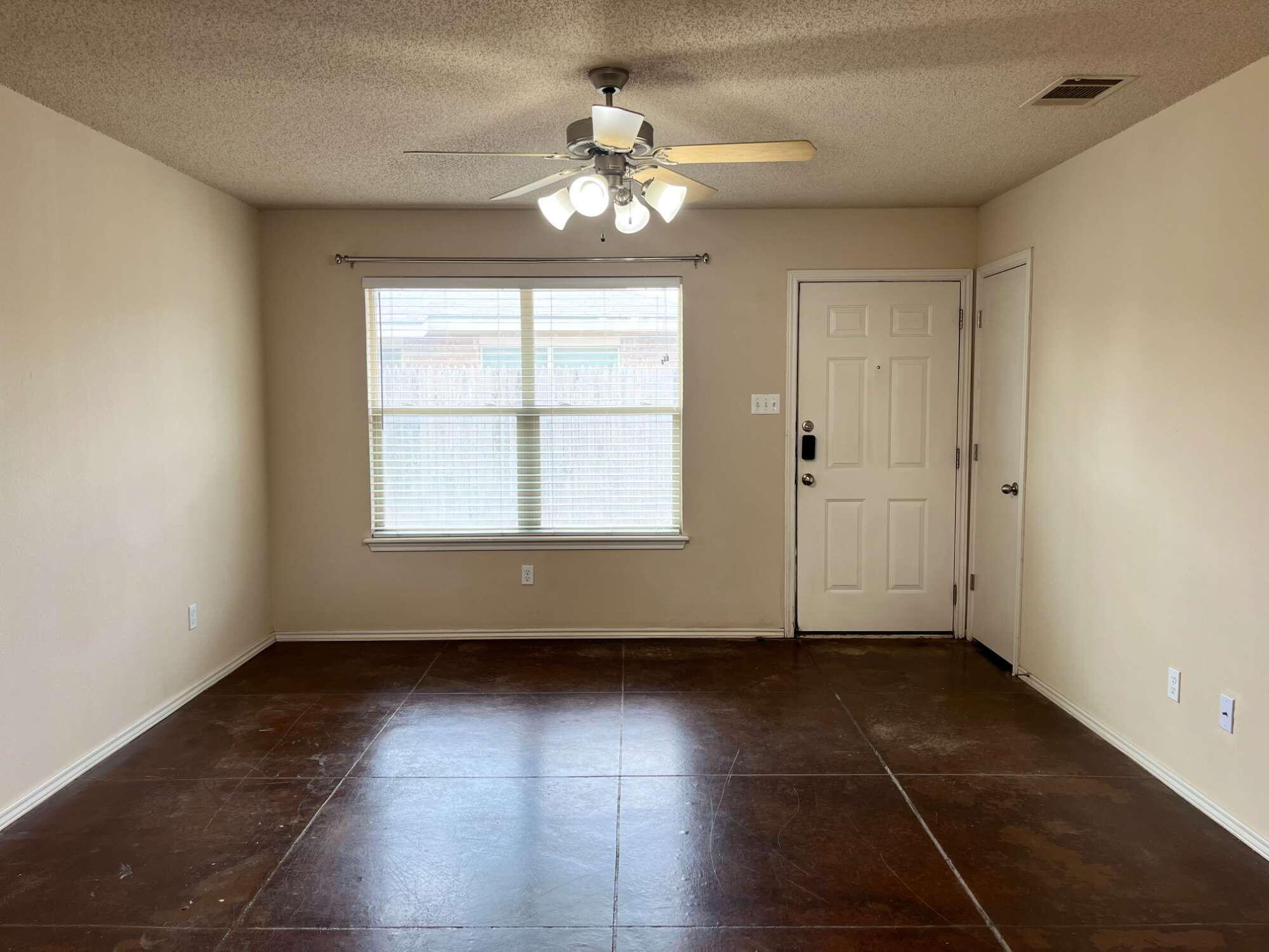2401 73rd Street, Unit 6 Lubbock, TX 79423 - Photo 2 of 19 a view of an empty room with a window