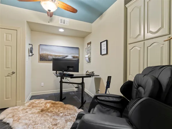 a bedroom with furniture and a flat screen tv