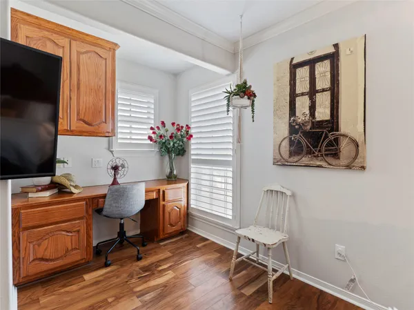a work room with furniture and wooden floor
