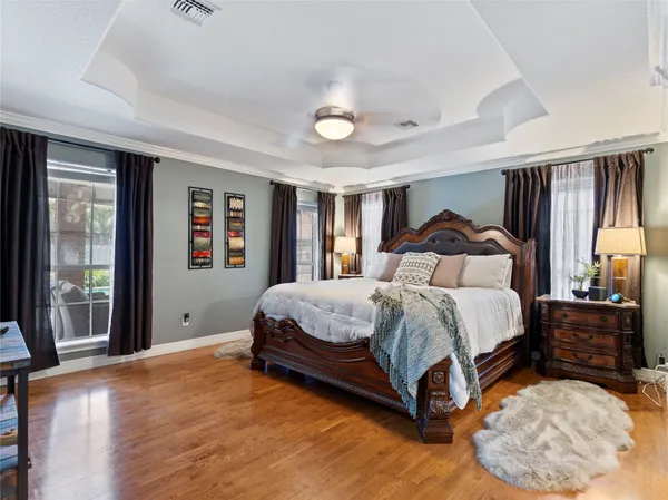 a bedroom with a bed lamp closet and large window