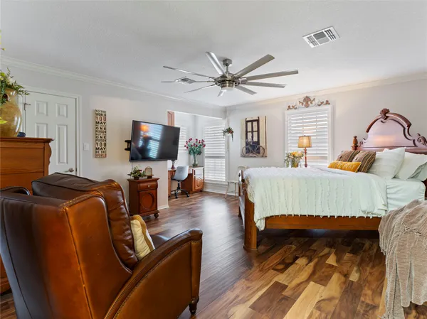 a bedroom with furniture and a flat screen tv