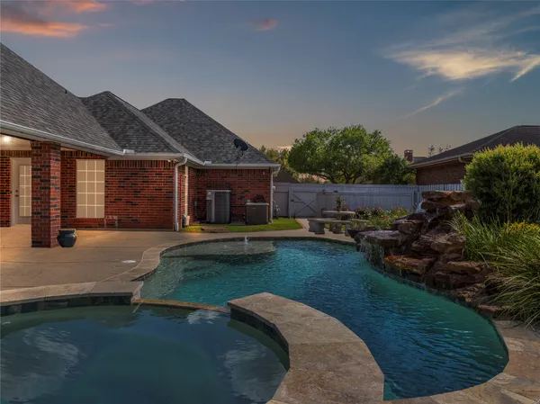 a view of a house with swimming pool patio and garden