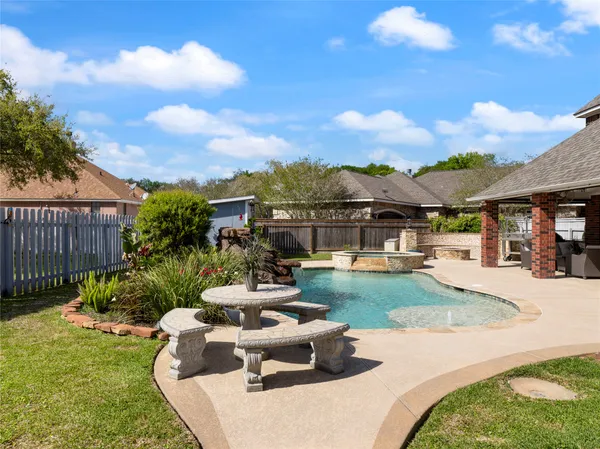 a view of a backyard with sitting area
