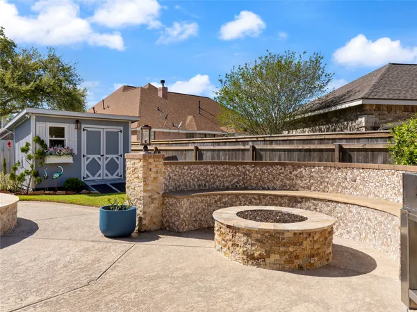 a front view of a house with swimming pool fire pit and outdoor seating