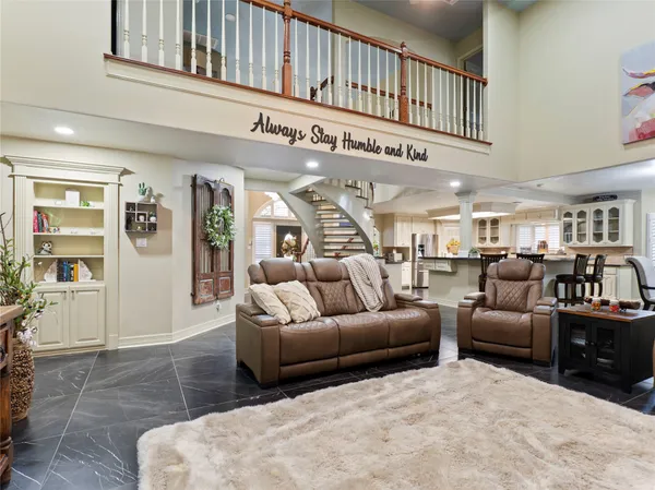 a living room with furniture a ceiling fan and a rug
