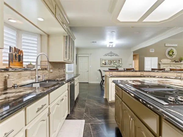 a kitchen with stainless steel appliances granite countertop a stove and a sink
