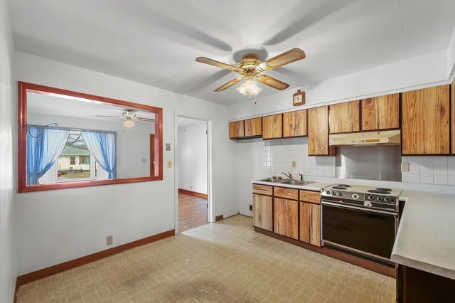a kitchen with stainless steel appliances a stove a sink and a refrigerator