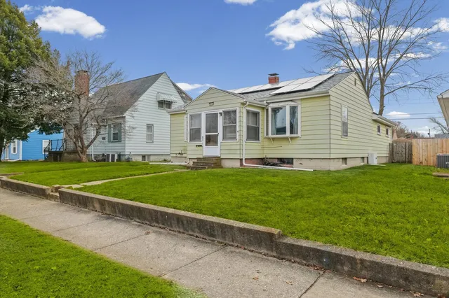 a front view of house with yard and green space