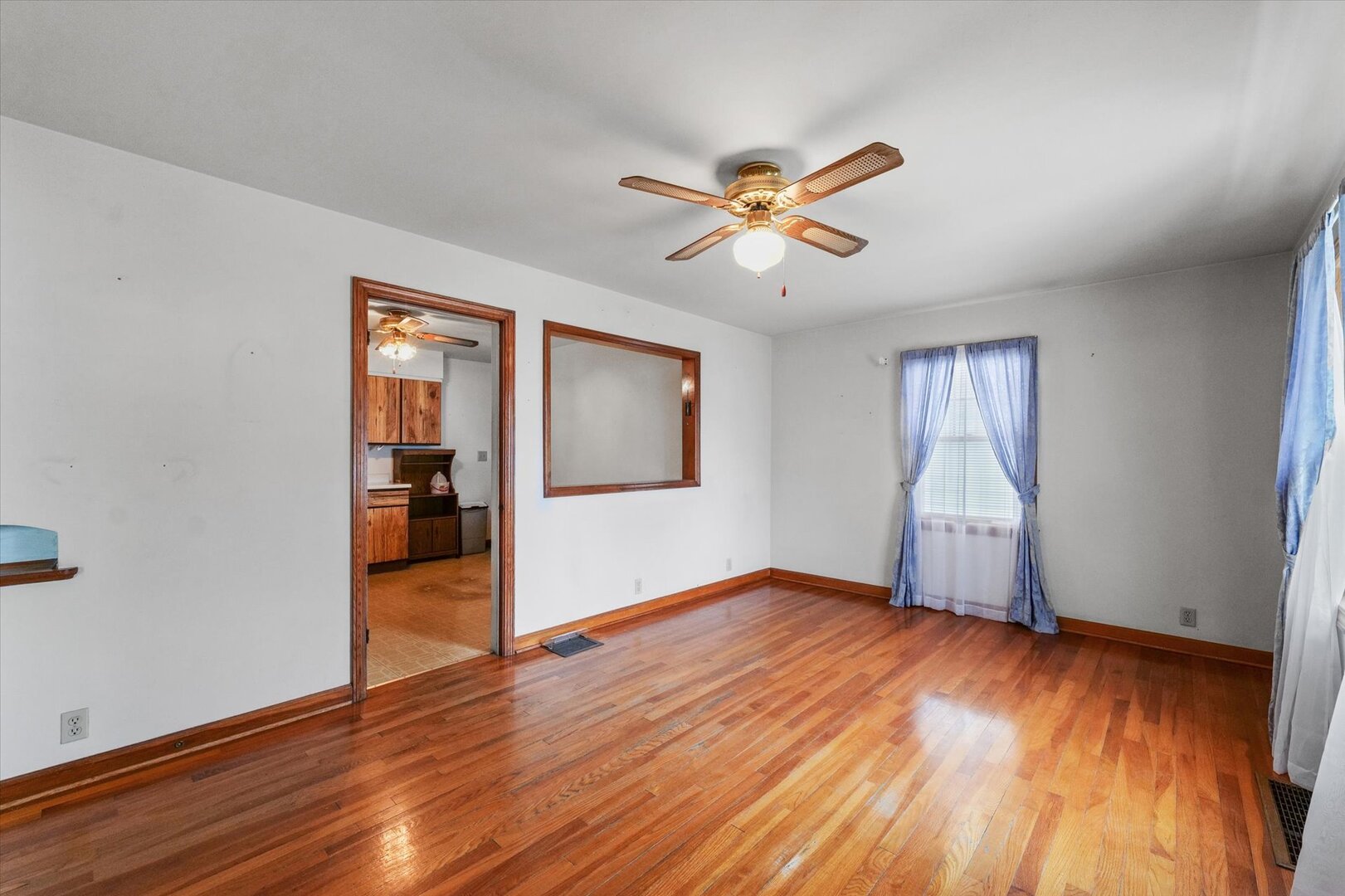 811 West Harvard Street Champaign, IL 61820 - Photo 8 of 34 a view of empty room with wooden floor and fan