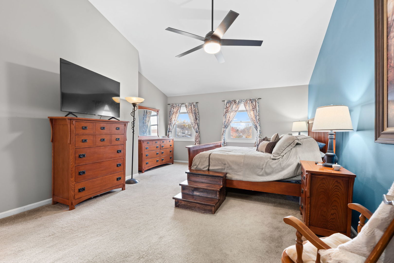 1289 Westport Ridge Crystal Lake, IL 60014 - Photo 9 of 27 a spacious bedroom with a bed a flat screen tv and a chandelier
