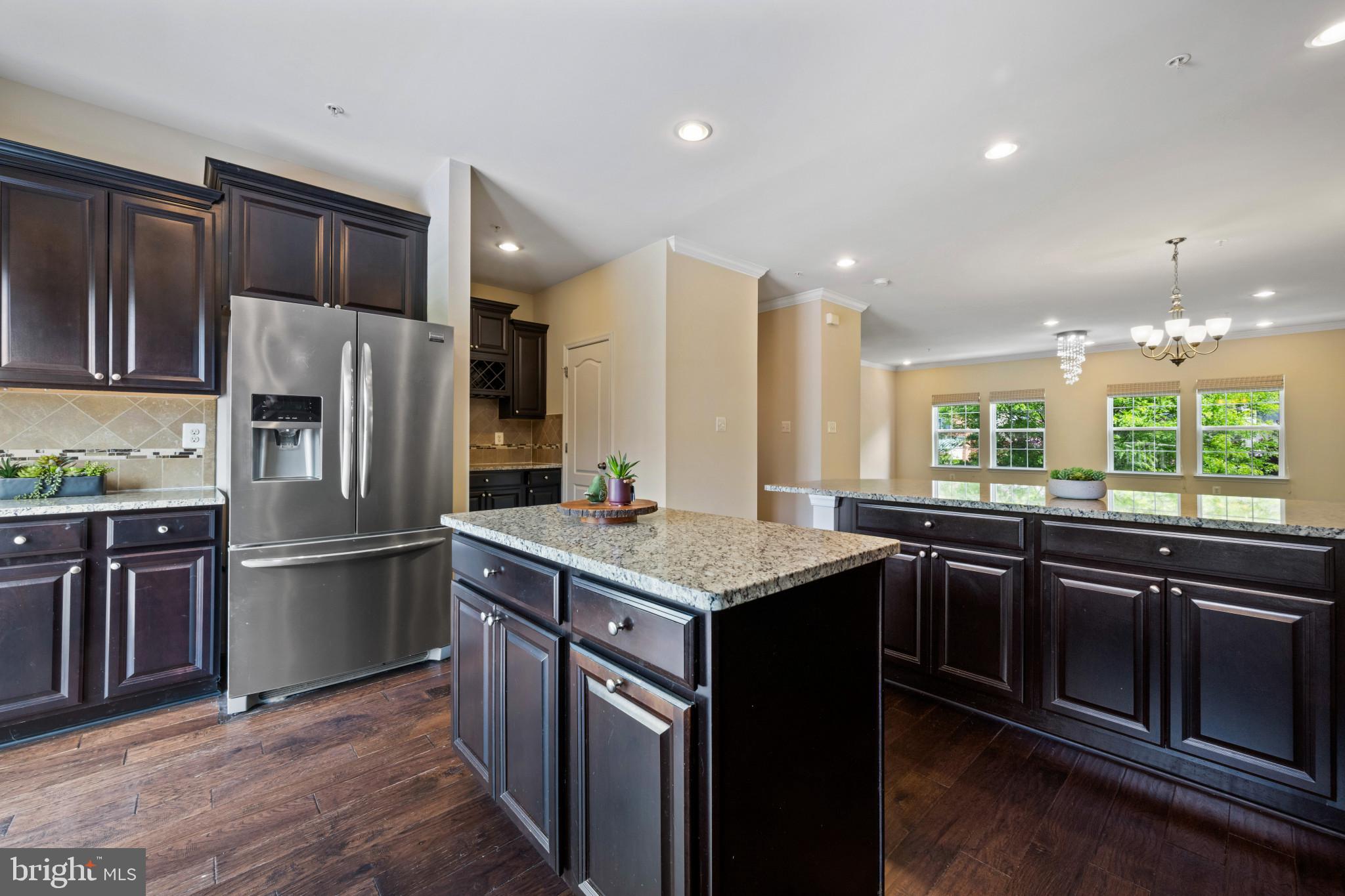 7062 Foxton Way Hanover, MD 21076 - Photo 12 of 41 a kitchen with stainless steel appliances granite countertop a sink stove and refrigerator