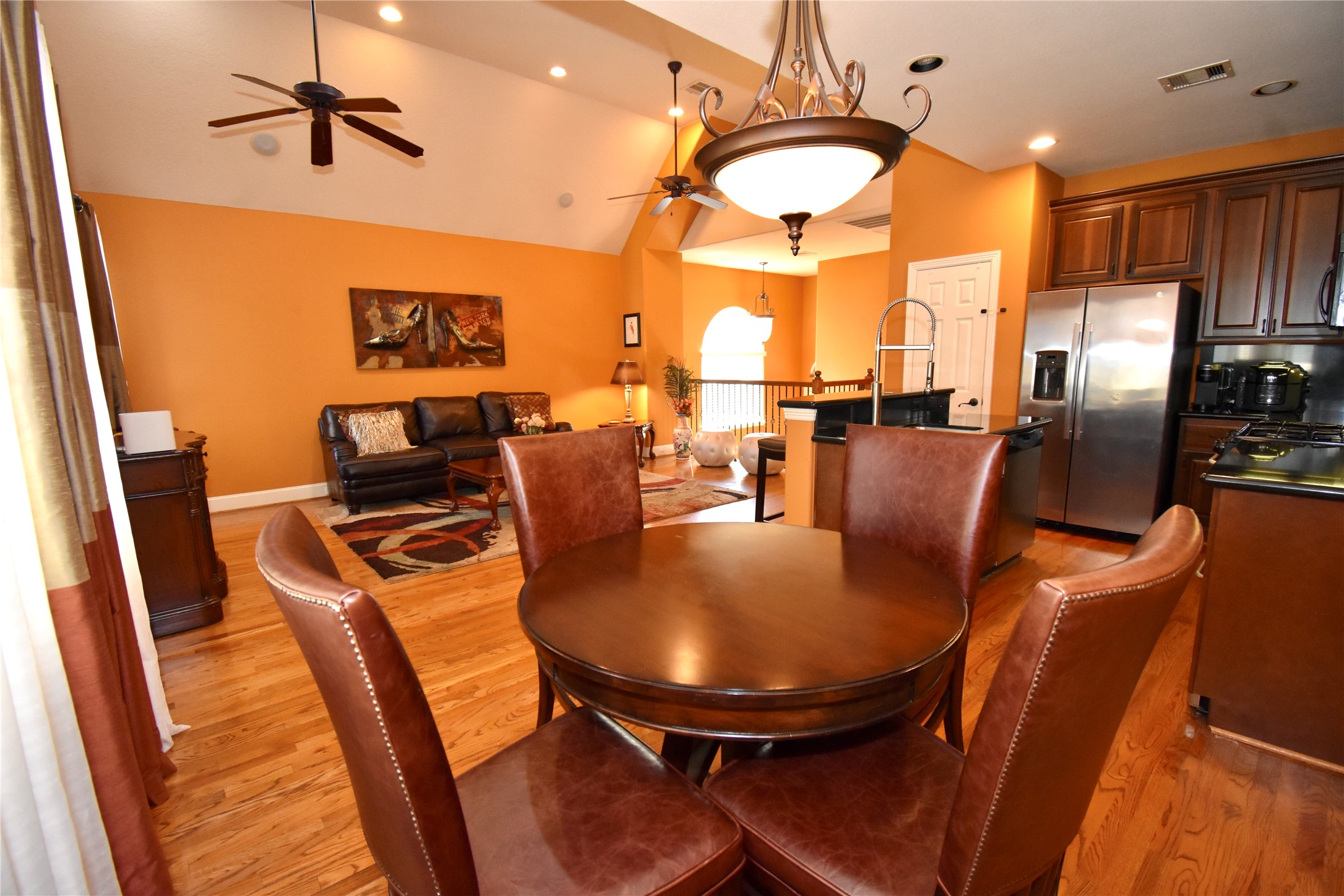 326 Gregg Street Houston, TX 77020 - Photo 11 of 26 a view of a dining room with furniture a chandelier and wooden floor
