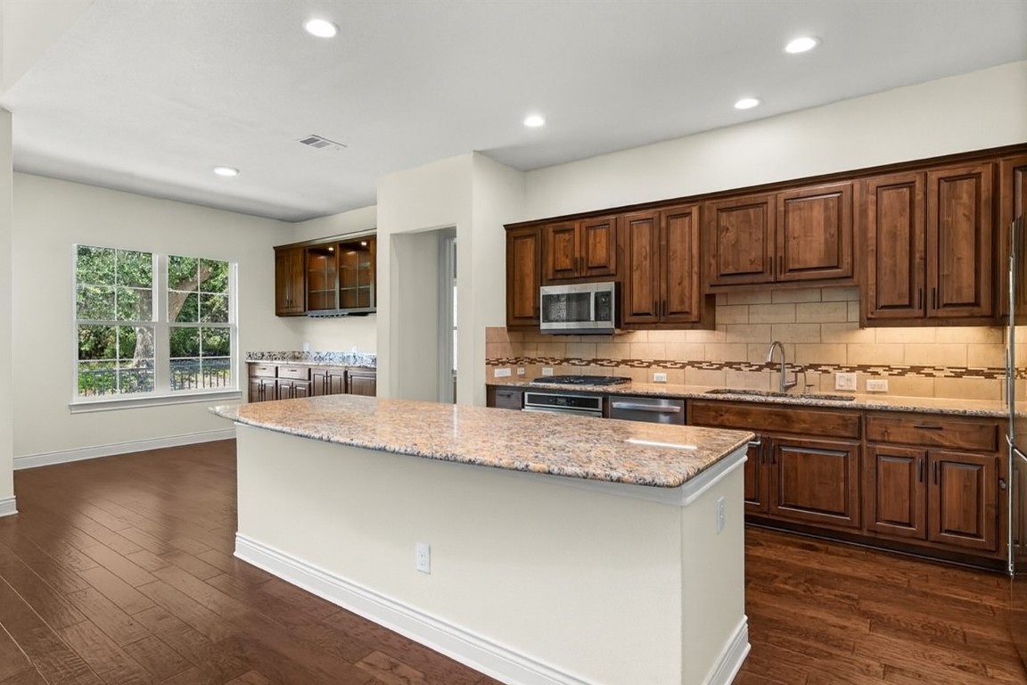 404 Amiata Avenue, Unit 34 Austin, TX 78734 - Photo 2 of 35 A gourmet kitchen awaits you featuring a large center island and plentiful counter space.