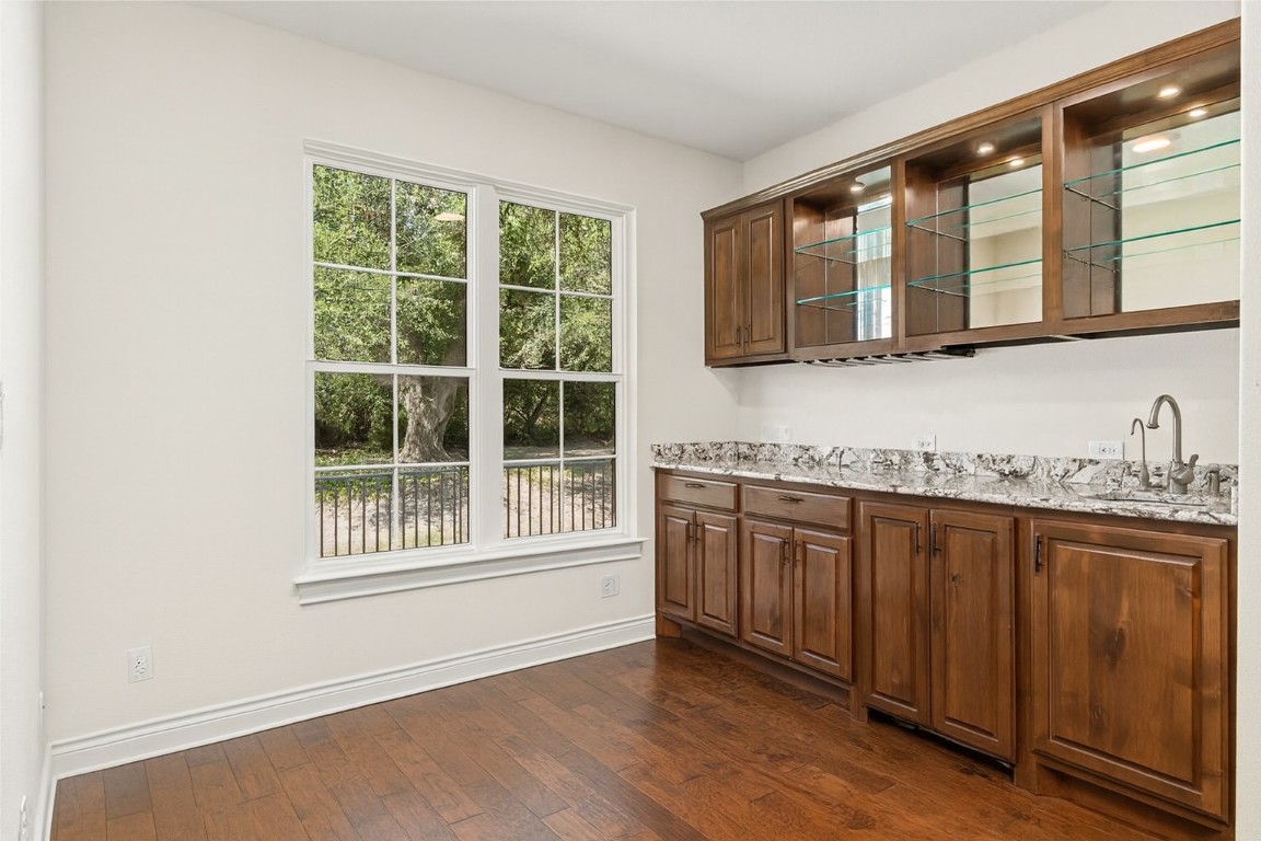 404 Amiata Avenue, Unit 34 Austin, TX 78734 - Photo 9 of 35 a kitchen with granite countertop a stove a sink and a refrigerator