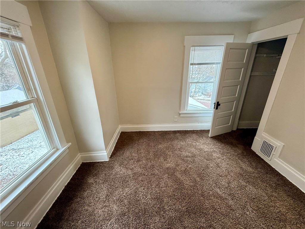 39 North Balch Street Akron, OH 44303 - Photo 18 of 19 Unfurnished bedroom featuring dark carpet and a closet