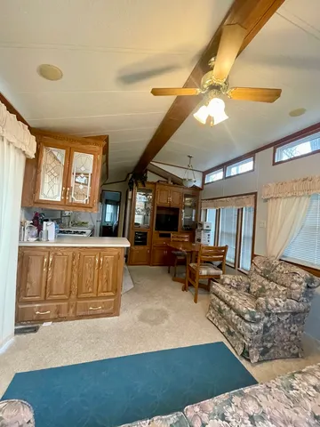 a room with pool table a flat screen tv and appliances
