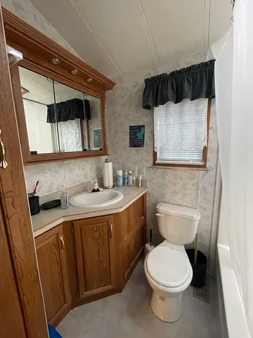 a bathroom with a toilet a sink and a shower
