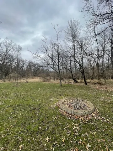 a view of a wooden house with a small yard