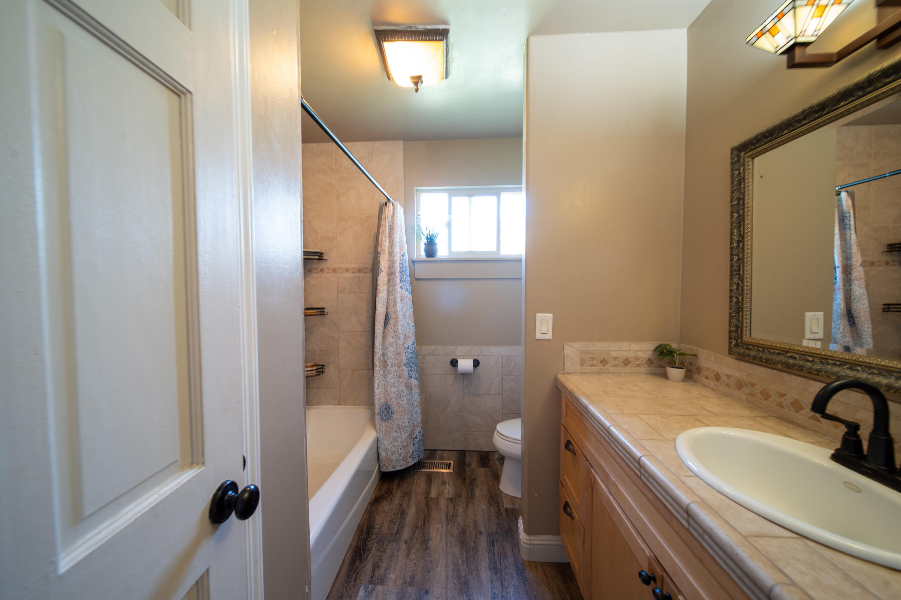 44040 Skyline Drive Three Rivers, CA 93271 - Photo 20 of 40 a bathroom with a granite countertop sink a mirror and a shower