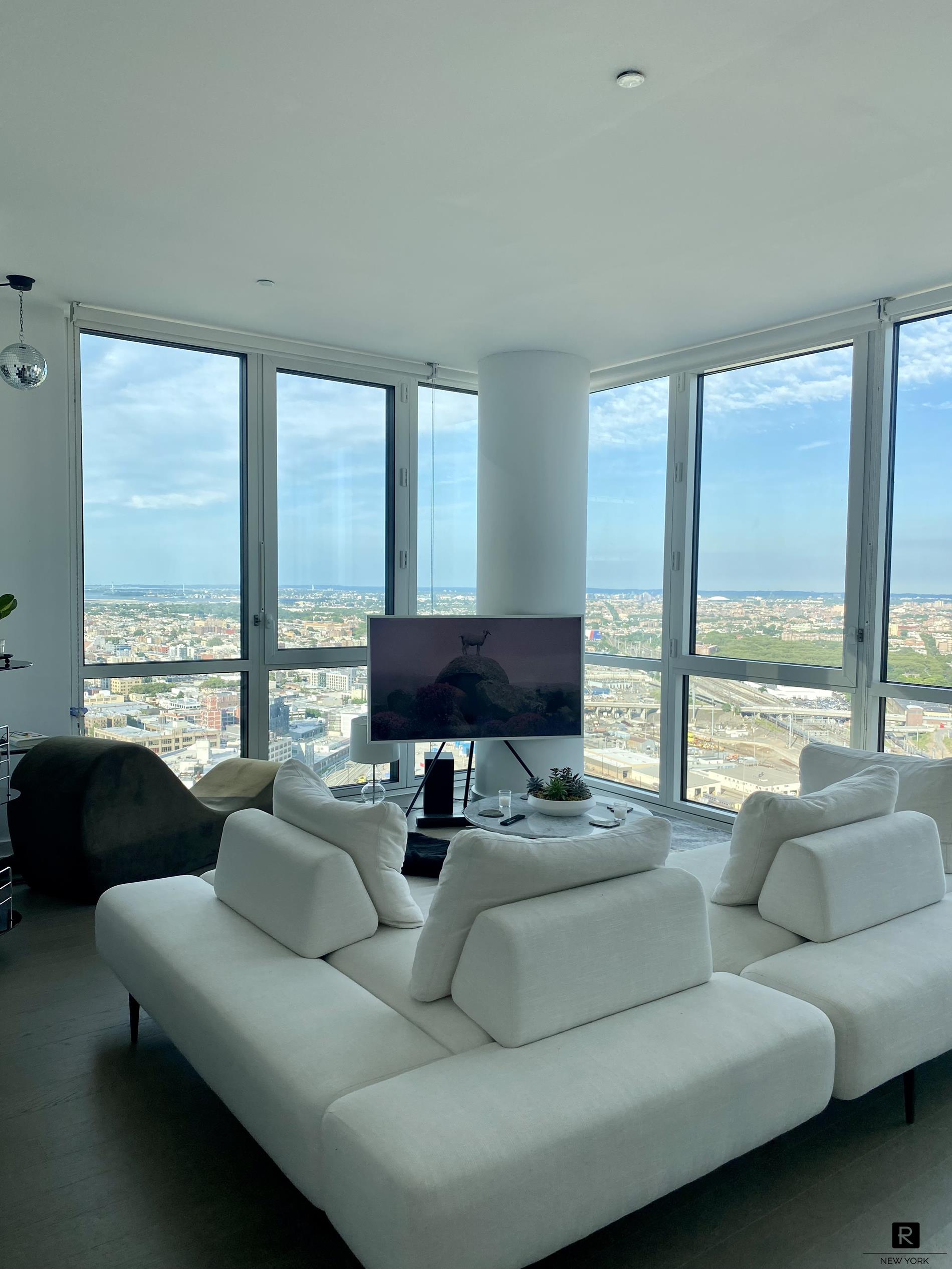 a living room with furniture and a large window