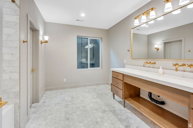 250 South Main Street, Unit 10 Alpine, UT 84004 - Photo 24 of 29 Spacious bathroom featuring a double vanity with a light wood-finish cabinet, white countertop, and gold-finish wall-mounted faucets
