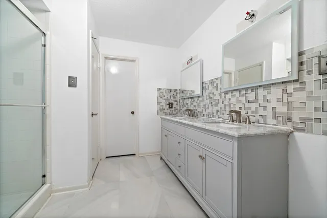 a bathroom with double sink and mirror