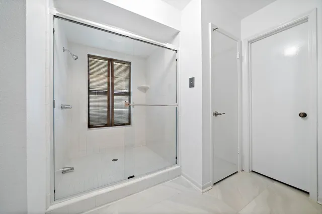 a bathroom with a bathtub and shower