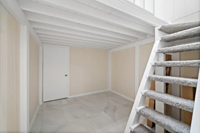 a view of an empty room with stairs