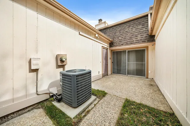 a view of grassy field with benches and trees all around
