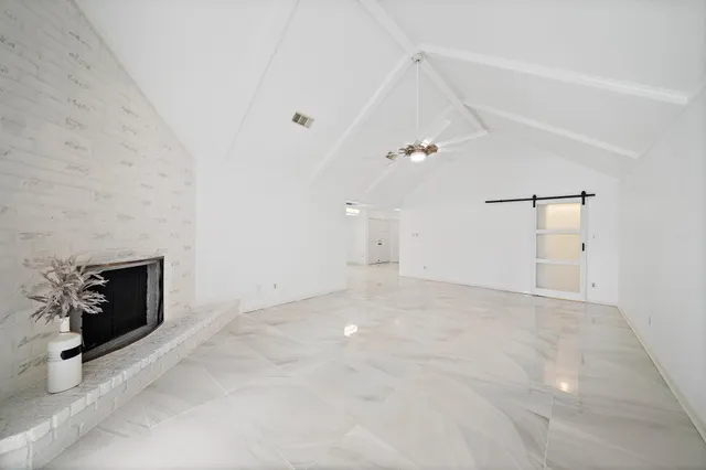 a view of an empty room with a fireplace