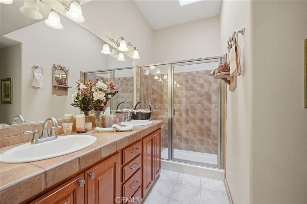 35780 Greer Road Murrieta, CA 92562 - Photo 35 of 56 Hall bathroom w walk in shower, dual sinks and skylight for natural light