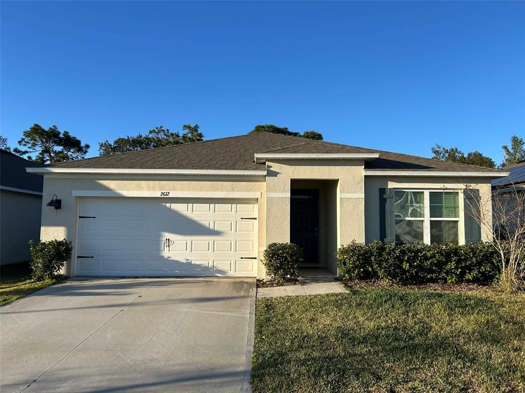 2612 Harmonia Hammock Road Harmony, FL 34773 - Photo 1 of 17 a front view of a house with a yard
