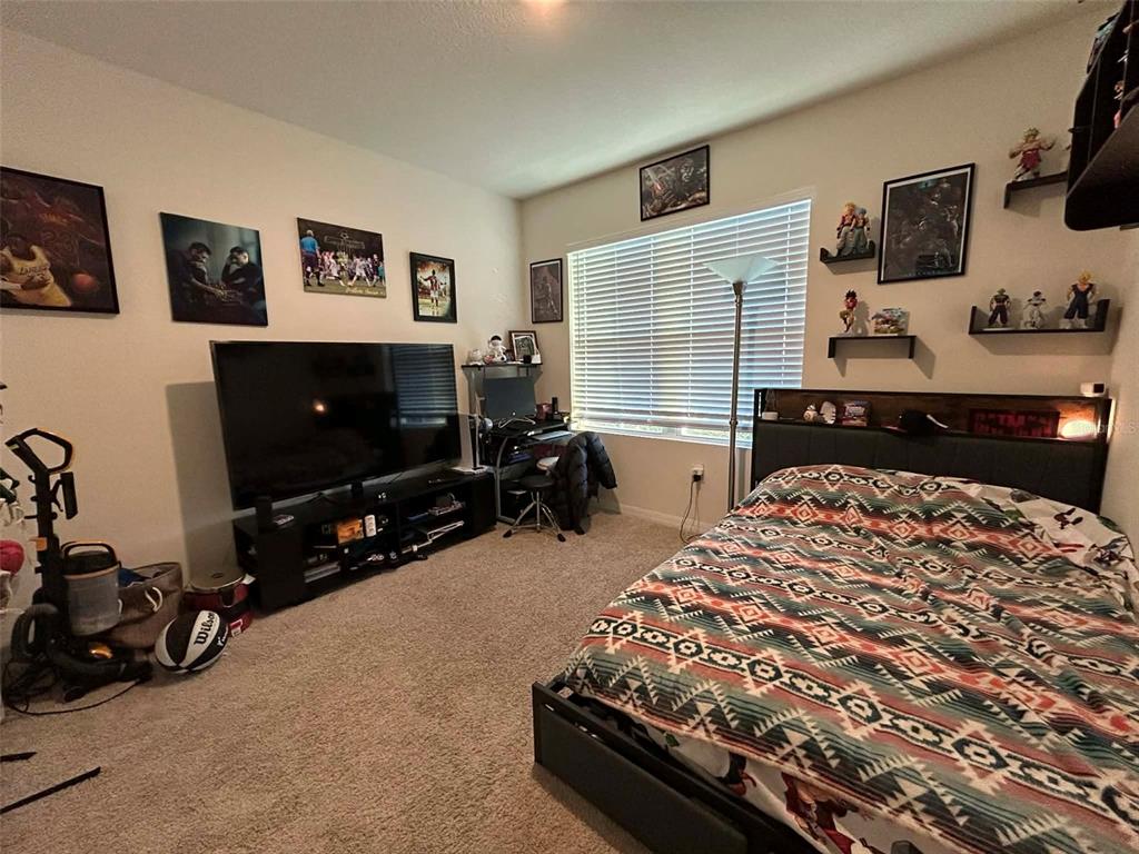 2612 Harmonia Hammock Road Harmony, FL 34773 - Photo 12 of 17 a bedroom with a bed and a flat screen tv