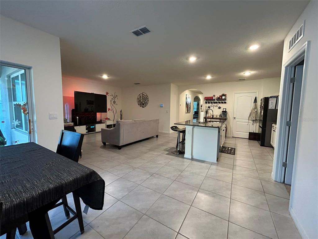 2612 Harmonia Hammock Road Harmony, FL 34773 - Photo 4 of 17 a kitchen with stainless steel appliances granite countertop a stove top oven a sink dishwasher and a refrigerator