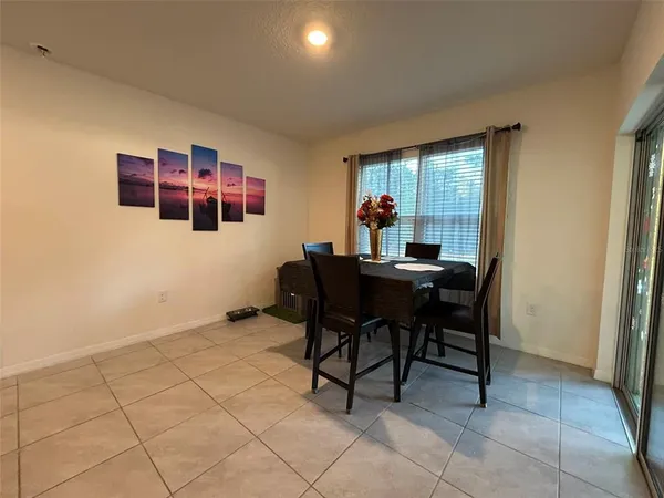 a dining room with furniture and a window