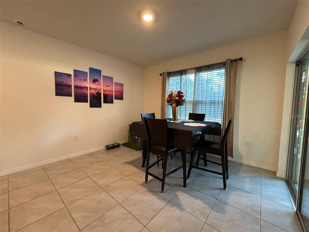 2612 Harmonia Hammock Road Harmony, FL 34773 - Photo 9 of 17 a dining room with furniture and a window