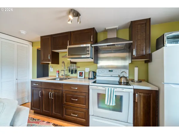 a kitchen with a stove and a refrigerator