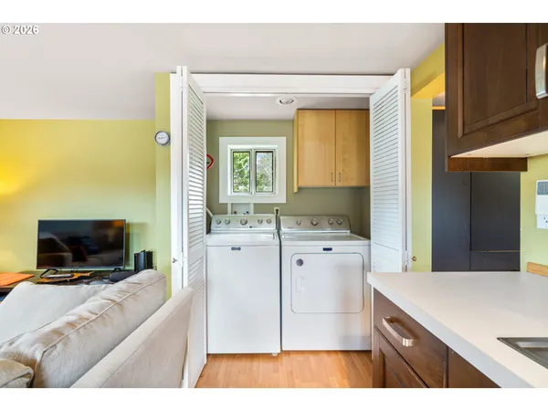 a living room with a flat screen tv and a dresser