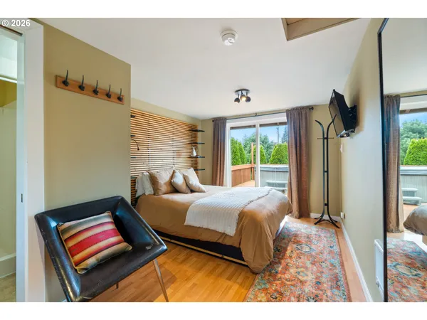 a bedroom with a bed and wooden floor