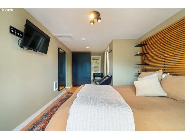 a bedroom with a bed and flat screen tv