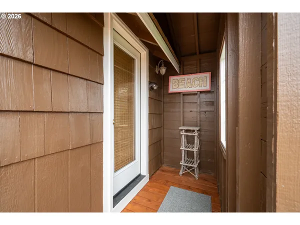 a bedroom with a large bed and a flat tv screen on dresser