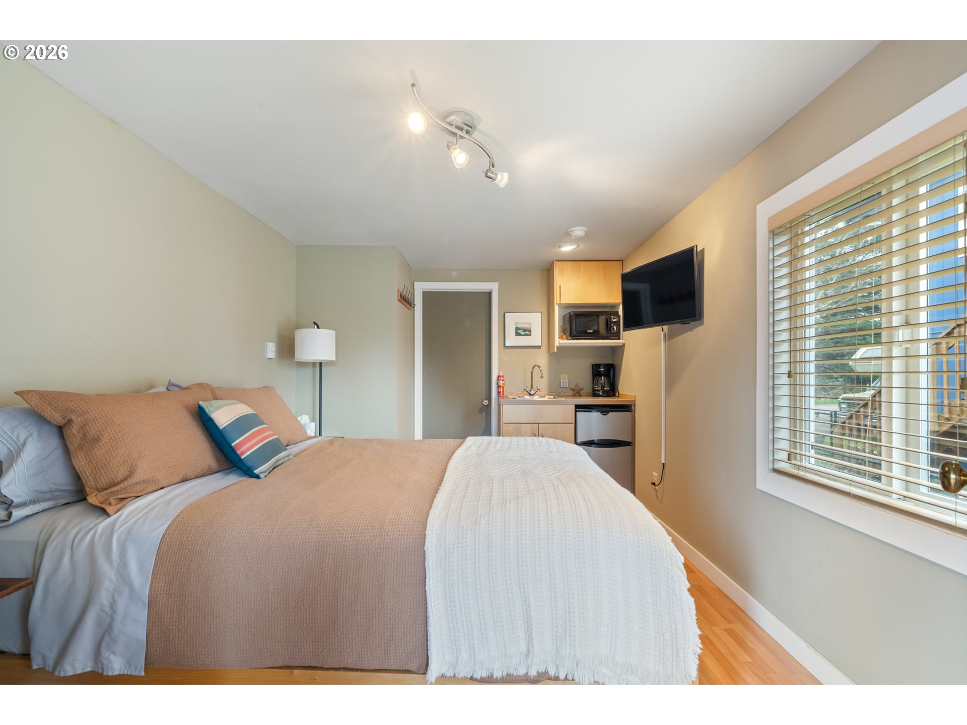 34650 2nd Street Cloverdale, OR 97112 - Photo 23 of 37 a bedroom with a large bed and a flat tv screen on dresser