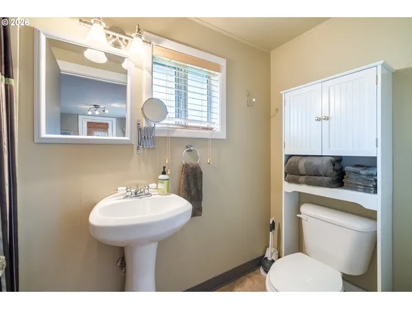 a bathroom with a sink a toilet and mirror